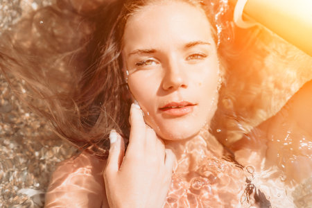 Woman summer travel sea. Happy tourist enjoy taking picture outdoors for memories. Woman traveler posing on the beach at sea surrounded by volcanic mountains, sharing travel adventure journeyの写真素材