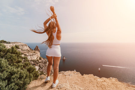 Woman sea pilates. Sporty middle-aged woman training in pilates on yoga mat by sea. concepts of health, wellness, and mindfulness in exercise, promoting the benefits of active and balanced lifestyleの写真素材