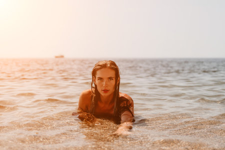 Woman summer travel sea. Happy tourist enjoy taking picture outdoors for memories. Woman traveler posing on the beach at sea surrounded by volcanic mountains, sharing travel adventure journeyの写真素材