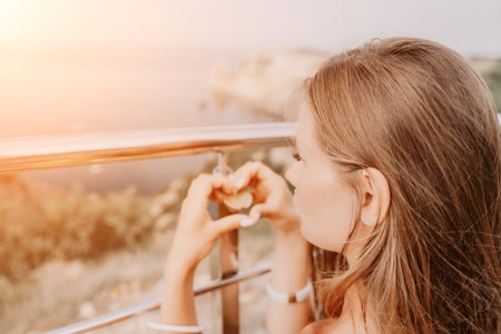 Hands, lock, heart, love, valentines day. Close-up of a womans hands holding heart shaped padlock with a heart. The concept of Valentines day, wedding, symbol of love and fidelity.の写真素材