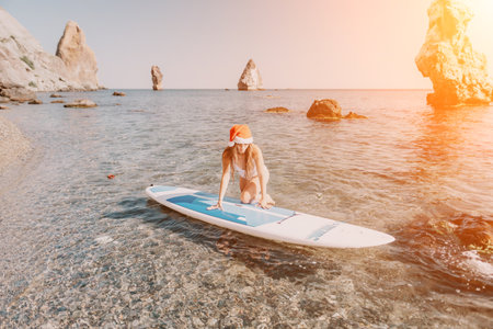 Woman sea sup. Close up portrait of happy young caucasian woman with long hair in Santa hat looking...