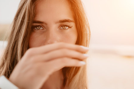 Happy woman portrait in cafe. Boho chic fashion style. Outdoor photo of young happy woman with long hair, sunny weather outdoors sitting in modern cafe.の写真素材