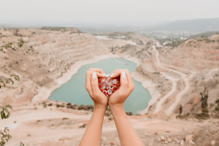 Woman travel portrait. Happy woman with long hair looking at camera and smiling. Close up portrait cute woman is posing on a heart shaped lake - travel destinationの写真素材