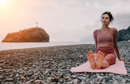 Woman sea pilates. Sporty happy middle aged woman practicing fitness on beach near sea, smiling active female training with ring on yoga mat outside, enjoying healthy lifestyle, harmony and meditationの写真素材