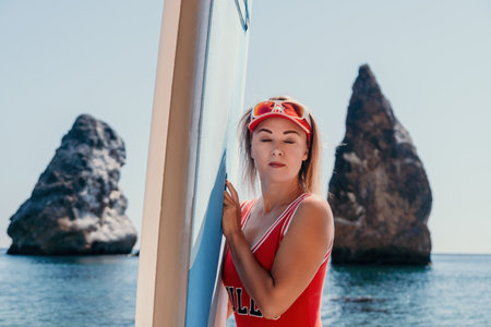 Woman sea sup. Close up portrait of happy young caucasian woman with blond hair looking at camera...