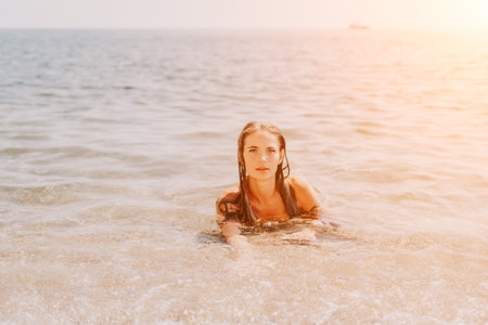 Woman summer travel sea. Happy tourist enjoy taking picture outdoors for memories. Woman traveler posing on the beach at sea surrounded by volcanic mountains, sharing travel adventure journeyの写真素材