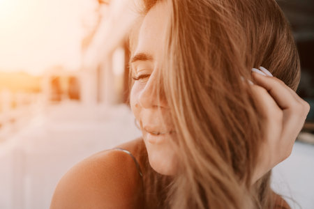 Happy woman portrait in cafe. Boho chic fashion style. Outdoor photo of young happy woman with long hair, sunny weather outdoors sitting in modern cafe.の写真素材