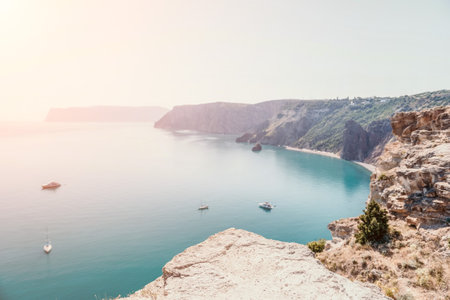 Aerial view from above on calm azure sea and volcanic rocky shores. Small waves on water surface in motion blur. Nature summer ocean sea beach background. Nobody. Holiday, vacation and travel conceptの写真素材