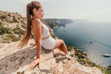 Woman sea pilates. Sporty middle-aged woman training in pilates on yoga mat by sea. concepts of health, wellness, and mindfulness in exercise, promoting the benefits of active and balanced lifestyleの写真素材