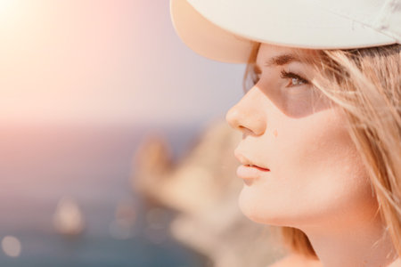 Woman travel sea. Happy tourist in hat enjoy taking picture outdoors for memories. Woman traveler...