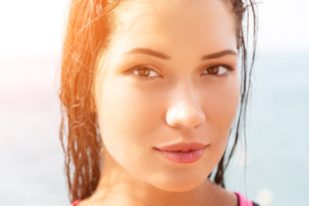 Woman sea sup. Close up portrait of beautiful young caucasian woman with black hair and freckles...