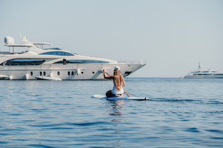 Woman sea sup. Close up portrait of happy young caucasian woman with long hair looking at camera and...