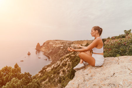 Woman sea pilates. Sporty happy middle aged woman practicing fitness on beach near sea, smiling active female training on yoga mat outside, enjoying healthy lifestyle, harmony and meditation.の写真素材