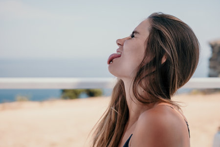 Happy woman portrait in cafe. Boho chic fashion style. Outdoor photo of young happy woman with long hair, sunny weather outdoors sitting in modern cafe.の写真素材