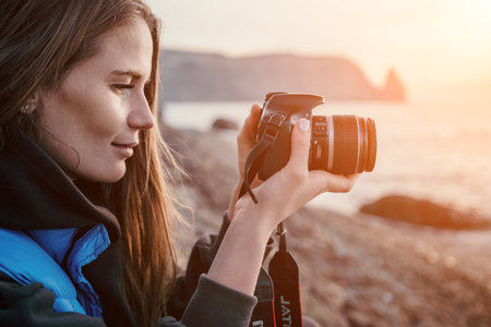 Woman travel sea. Happy tourist enjoy taking picture outdoors for memories. Woman traveler looks at...