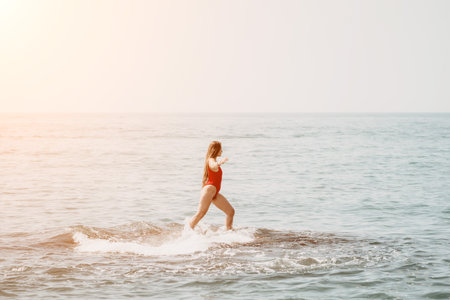 Woman sea yoga. Happy woman meditating in yoga pose on the beach, ocean and rock mountains....
