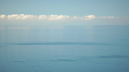 Aerial panoramic view of beautiful sunset above sea. Beautiful seascape. Sun glare, small waves on the water surface. Evening. Horizon. Nobody. No people. Never-ending beauty of nature.の写真素材