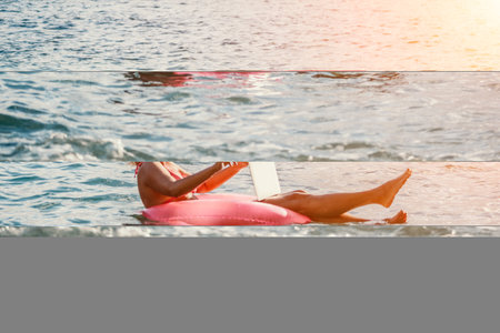 Woman works on laptop in sea. Freelancer, young blond woman in sunglases floating on an inflatable...