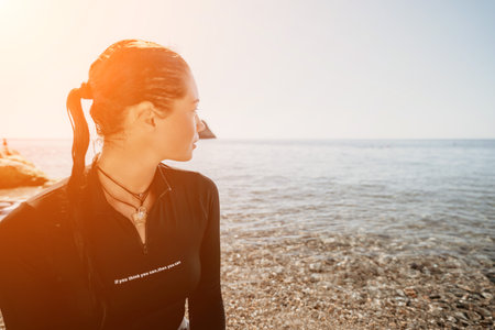 Woman summer travel sea. Happy tourist enjoy taking selfie photo outdoors for memories. Woman traveler posing on the beach at sea surrounded by volcanic mountains, sharing travel adventure journeyの写真素材