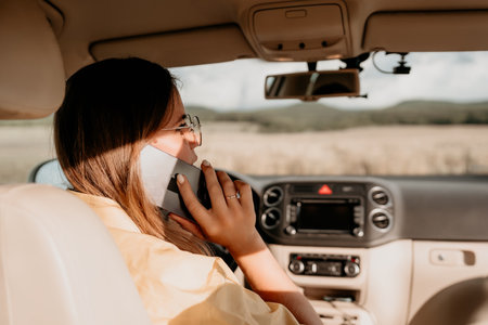 Relaxed business woman talking on video call on phone in automobile. Rested female professional...