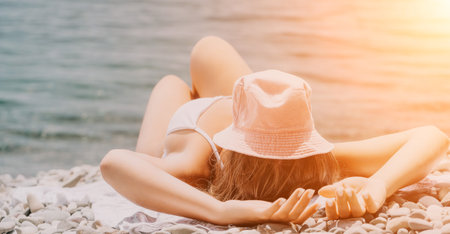 Happy smiling young woman sunbathing or tanning on a seaside beach during summer vacation. Slow...