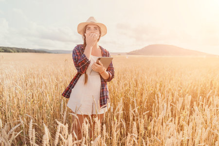 Woman wheat field. Agronomist, Woman farmer check golden ripe barley spikes in cultivated field....