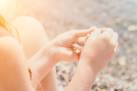 Woman eating milky almond nuts. A young caucasian woman chopping fresh green almond after morning...