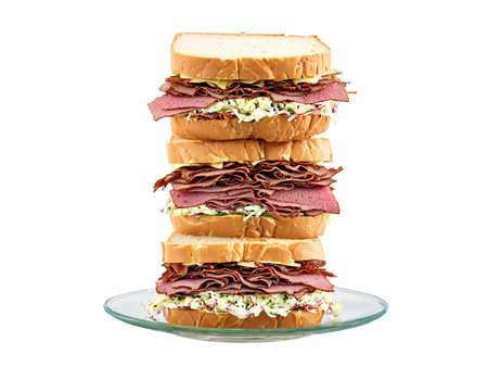 Sandwich rye with pastrami Swiss cheese and coleslaw served on a transparent glass plate deliの素材