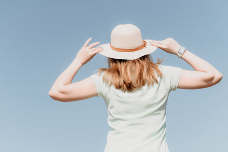 Woman travel sea. Happy tourist in hat enjoy taking picture outdoors for memories. Woman traveler...