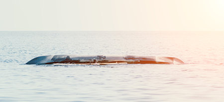Woman sea kayak. Happy smiling woman in kayak on ocean, paddling with wooden oar. Calm sea water and horizon in background. Active lifestyle at sea. Summer vacation.の写真素材