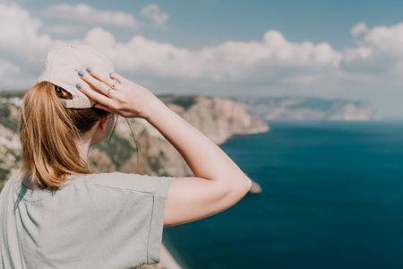 Woman travel sea. Happy tourist in hat enjoy taking picture outdoors for memories. Woman traveler...