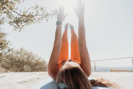 Woman in Orange Sportswear Doing Yoga on a Rooftop