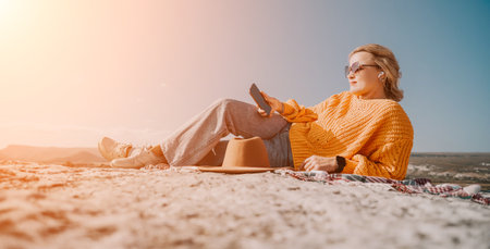 Relaxing on the Rock, Woman Enjoys the Viewの写真素材