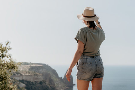 Woman in a Hat Looking at the Ocean