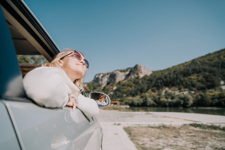 Woman in Car Window with Mountain Viewの写真素材