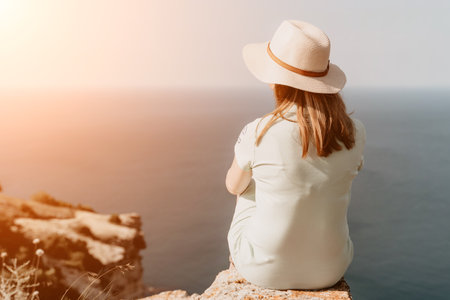 Woman travel sea. Happy tourist in hat enjoy taking picture outdoors for memories. Woman traveler...