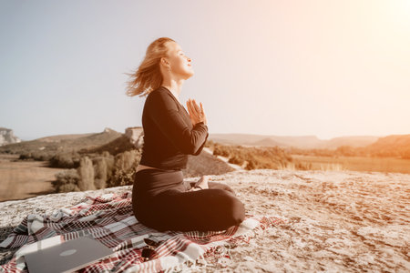 Woman Practicing Yoga on a Mountaintopの写真素材