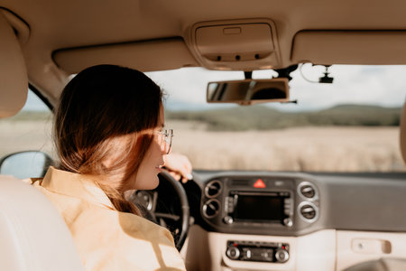 Woman in a Yellow Shirt Driving a Carの写真素材