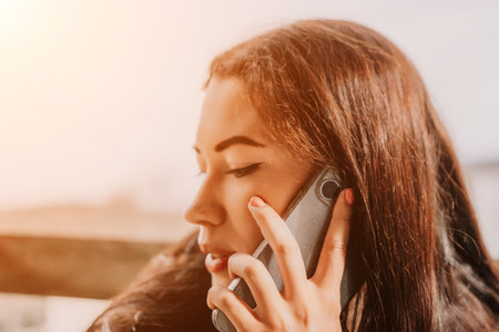 Young Woman Talking On Phone, Close Up Portraitの写真素材