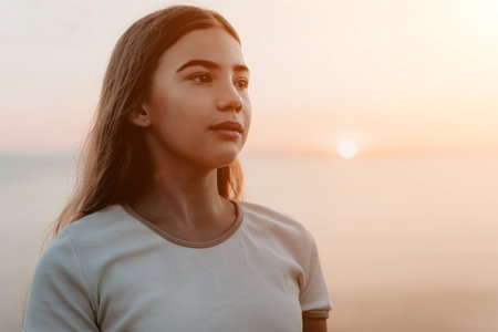 Young Woman Gazing at the Sunsetの写真素材
