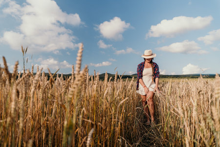 Woman in a Wheat Field on a Sunny Dayの写真素材