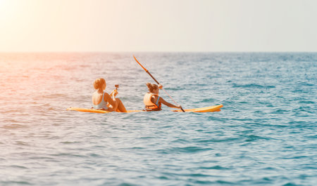 Two Women Kayaking in a Calm Oceanの写真素材