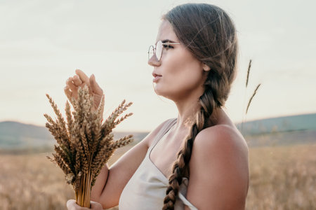 Woman in Wheat Field with Braided Hair and Glassesの写真素材