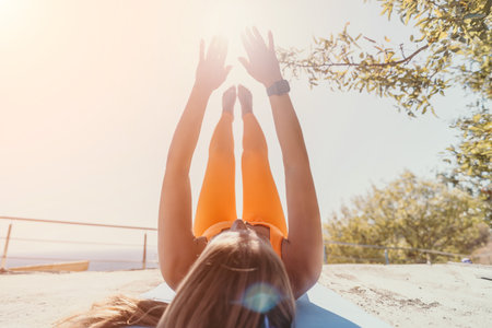 Young Woman Doing Yoga Outside, Legs in the Airの写真素材