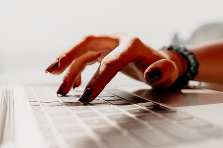 Hands Keyboard Typing Laptop - Closeup of hands typing on a laptop keyboard.