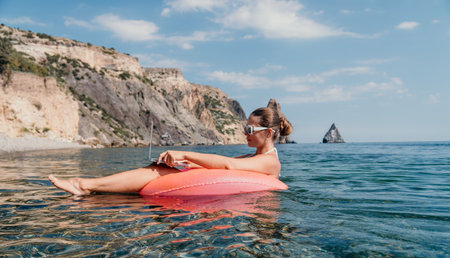 Woman, Float, Beach - Relaxing on a Float in the Ocean on a Sunny Day.の写真素材
