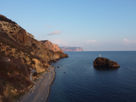 Aerial view from above on calm azure sea and pebbles beach. Small waves on cristal clear water surface in motion blur. Summer ocean sea beach background. Nobody. Holiday, vacation and travel conceptの写真素材