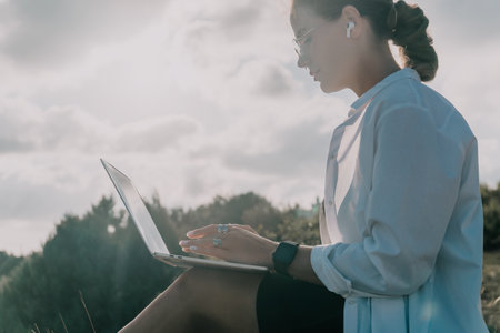 Woman Laptop Nature - Working Outdoors on Laptop in Natureの写真素材