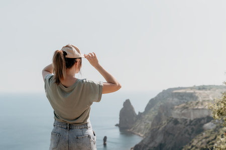 Woman in a Cap Admires the View from a Cliff