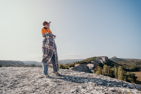 Woman in Plaid Blanket Admires Scenic Landscape